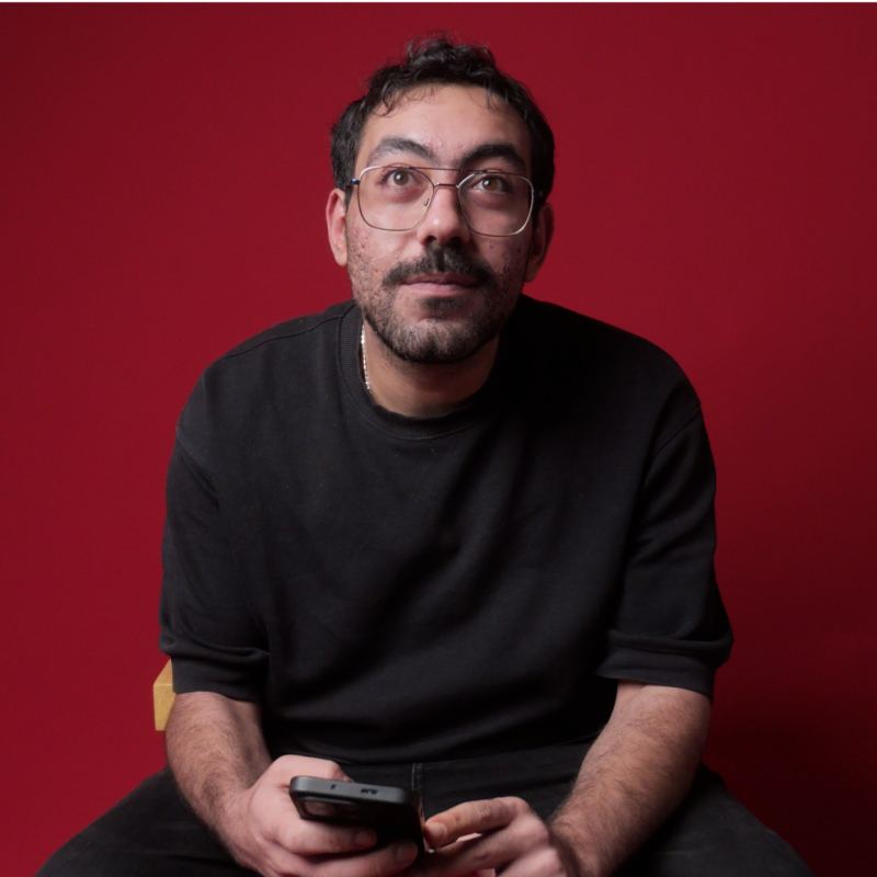 Portrait of Mahmoud El Bahr against a red background